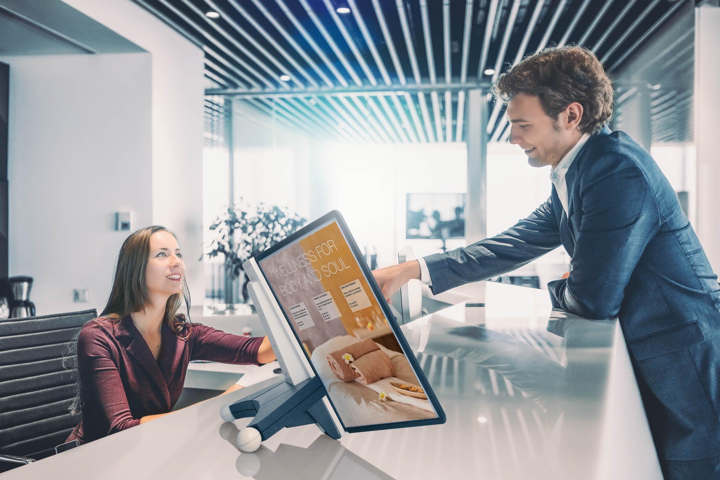 Modern office reception with digital tablet displaying wellness services for body and soul