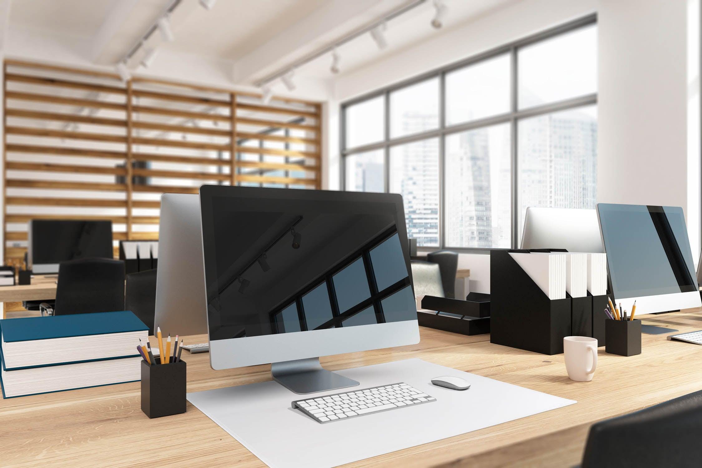 Modern office desk setup with computer, keyboard, mouse, and organizers for productive workspace