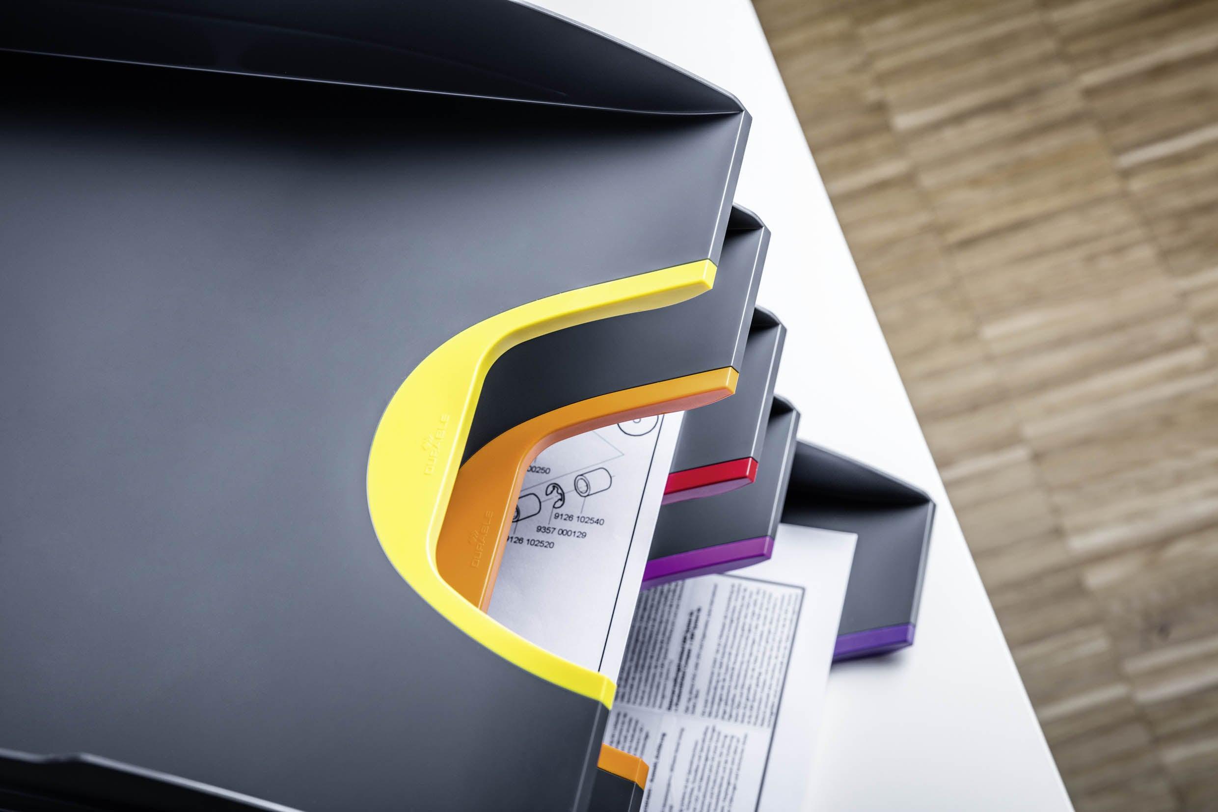 Modern office document trays with colorful handles for desktop organization and filing