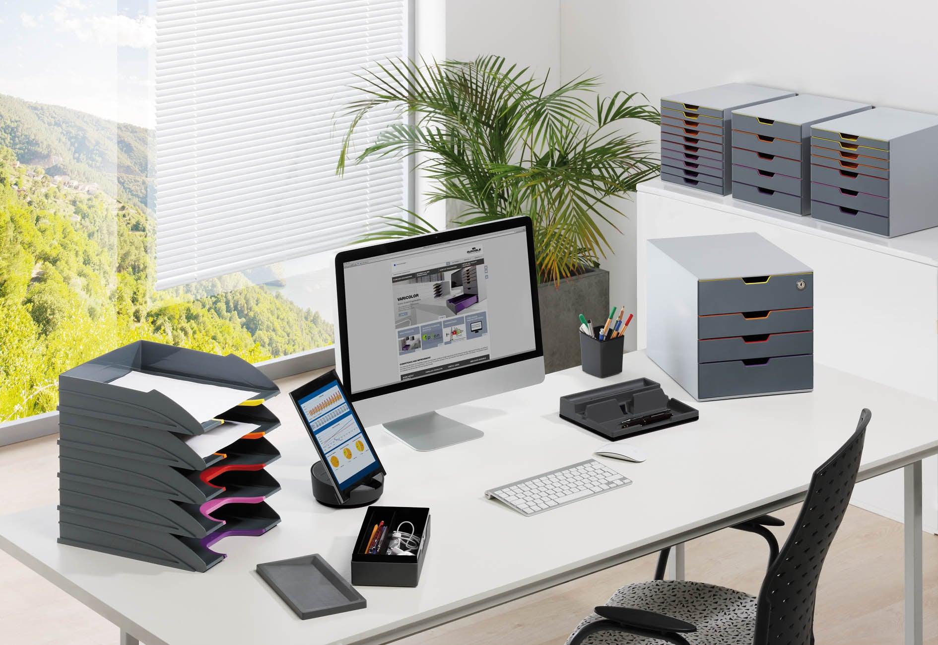 Modern office desk with gray file trays, drawer organizers, and computer setup for efficient workspace organization
