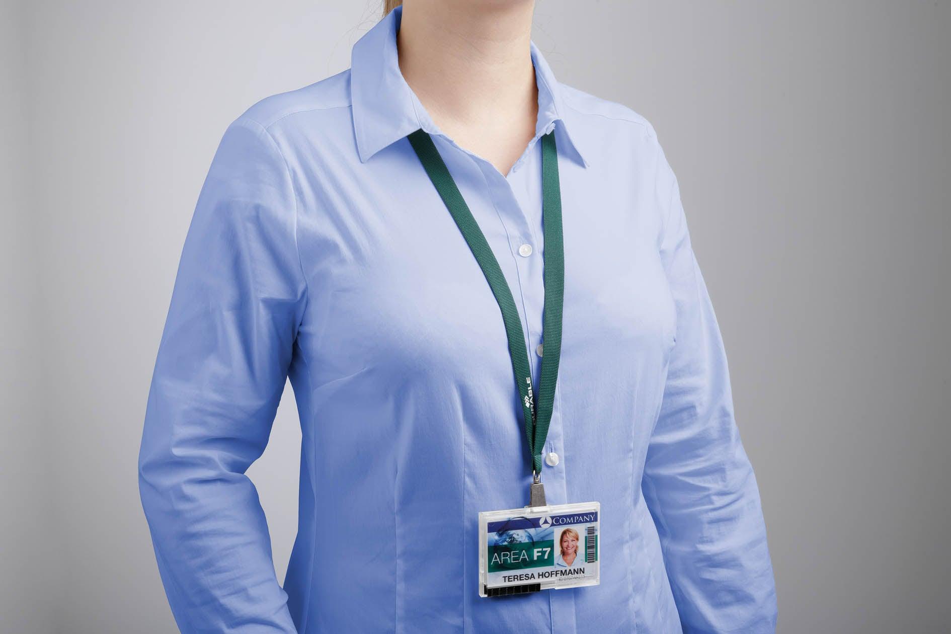Green lanyard with ID badge worn by person in blue shirt, ideal for office use