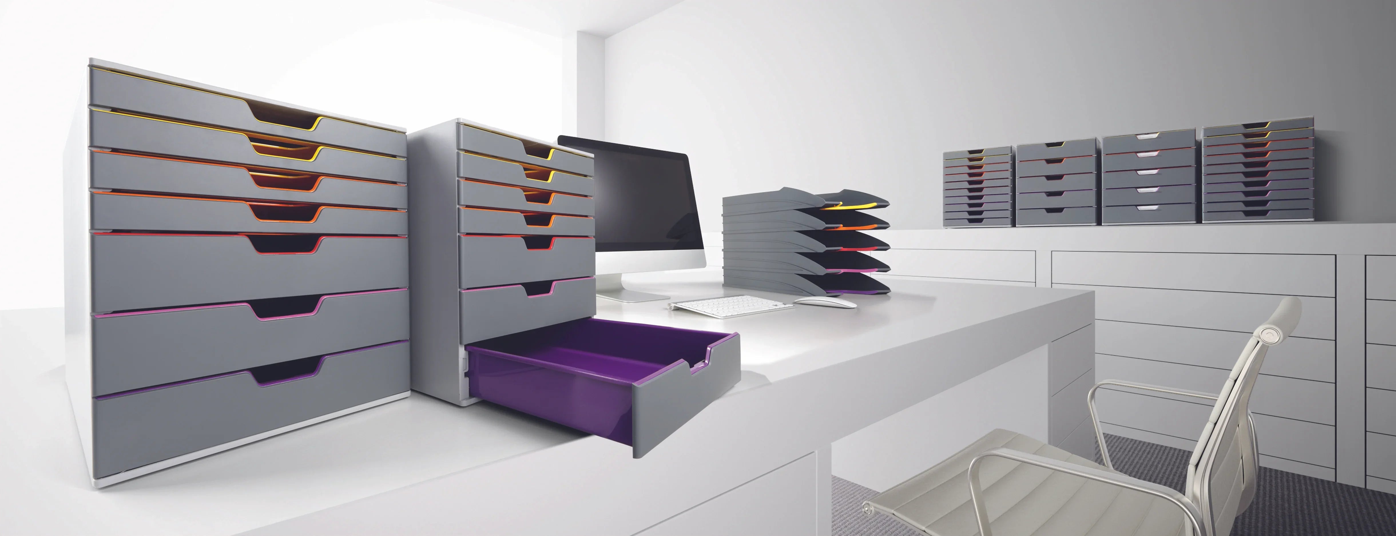 Modern office desk with gray modular drawers, colorful accents, and sleek organization for efficient workspace